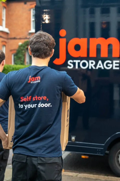 JamStorage crew carrying boxes to the JamStorage van outside a London home